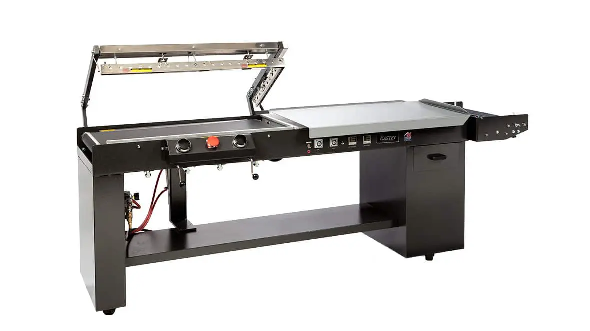 Industrial sealing machine with open lid.