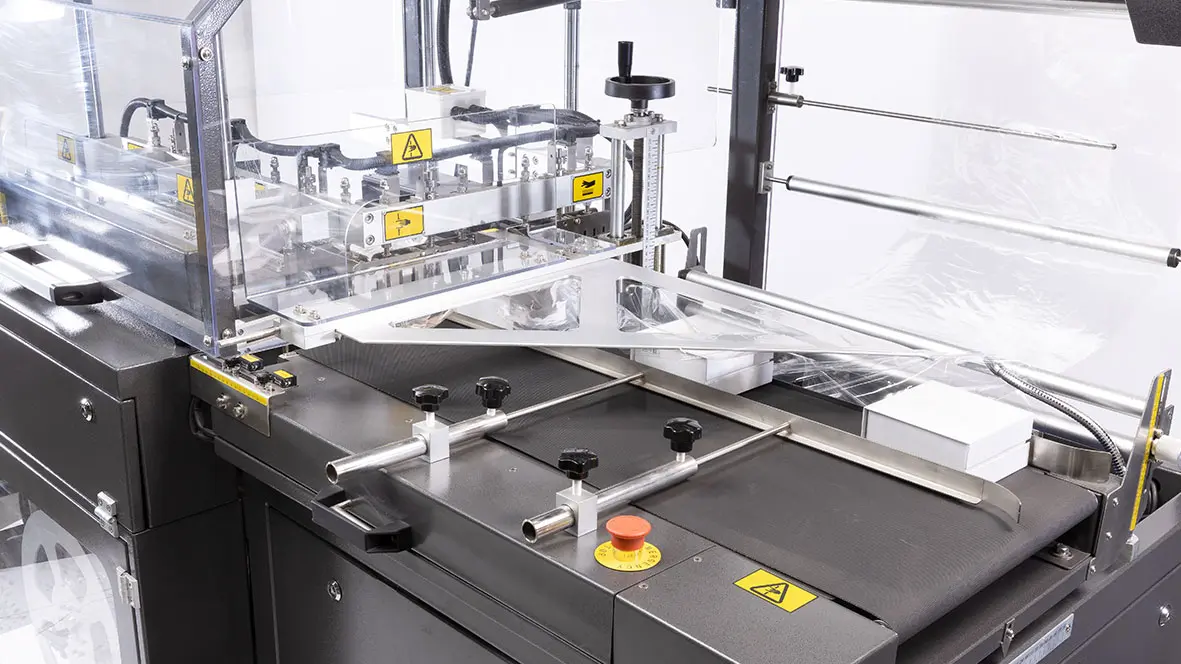 Packaging machine with conveyor and controls.