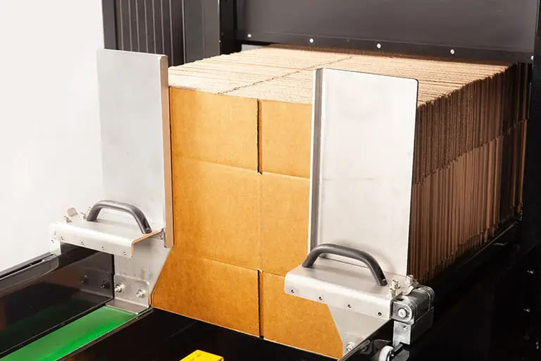 Cardboard boxes in a packaging machine.