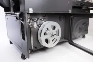 Industrial machine with large metal reel.