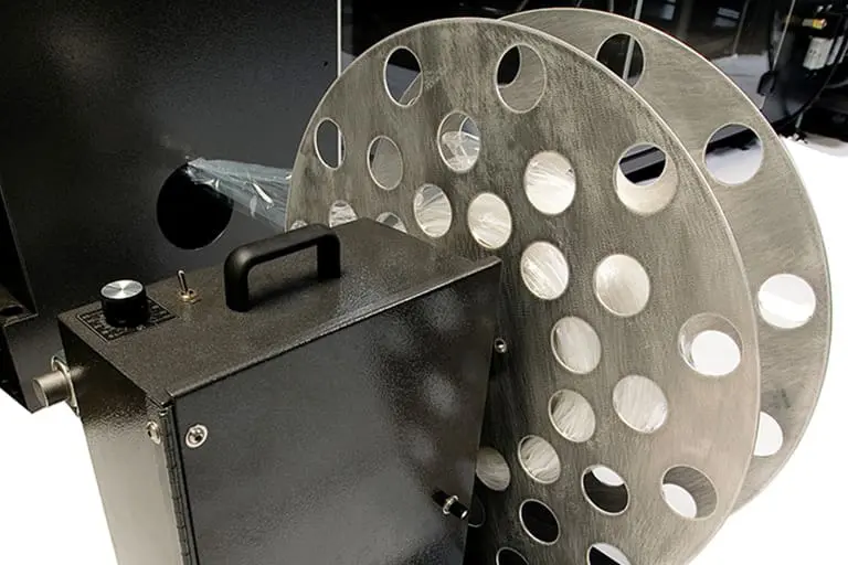 Large metal film reel and black machine.