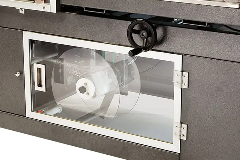 Industrial machine with a glass panel door.