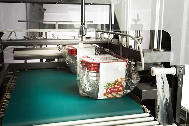 Packaging machine with wrapped food containers. Packaging machine with wrapped food containers.