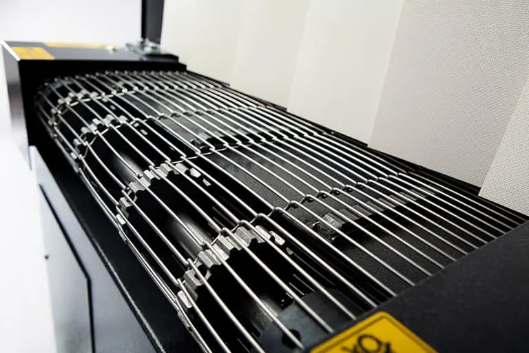 Grill grates on industrial machine surface.