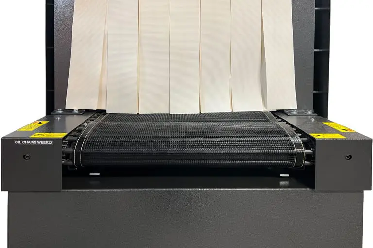 Industrial machine with conveyor and hanging strips.