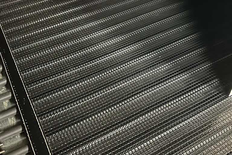 Close-up of a car radiator grille.