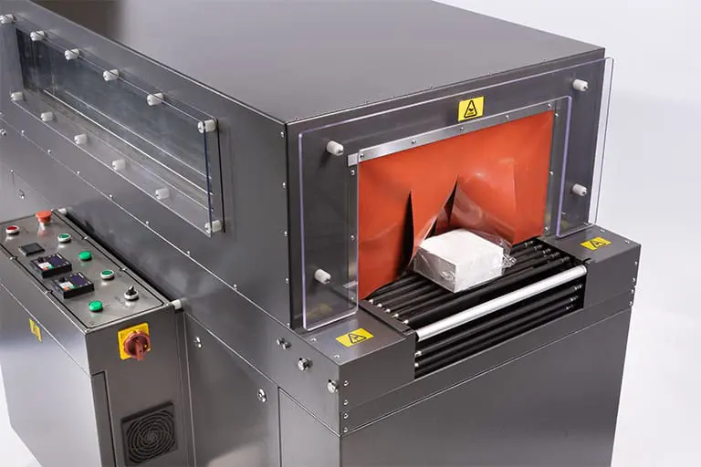 Industrial packaging machine with controls and package. Industrial packaging machine with controls and package.