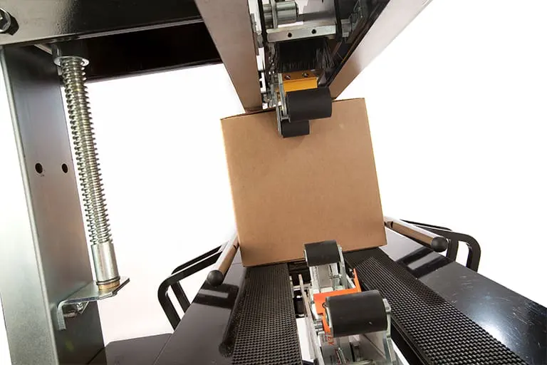 Cardboard box on conveyor belt machine.
