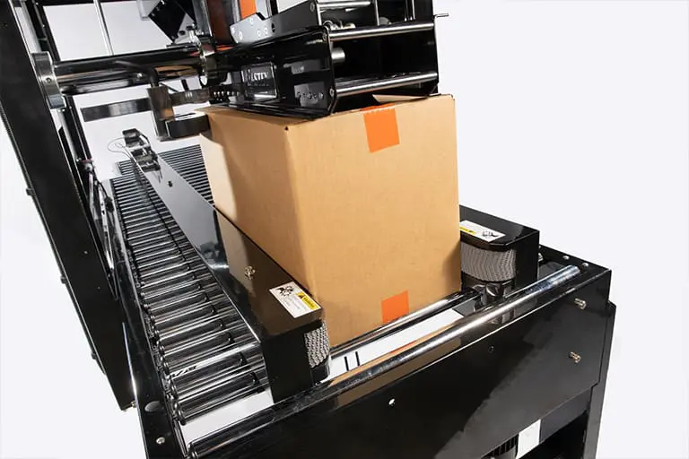 Cardboard box on automated conveyor belt.
