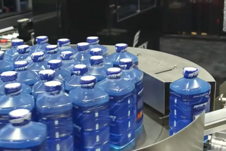 Blue plastic bottles on a conveyor belt.