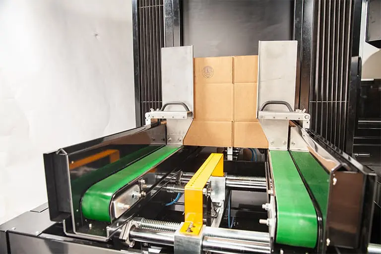 Cardboard box on automated conveyor belt.
