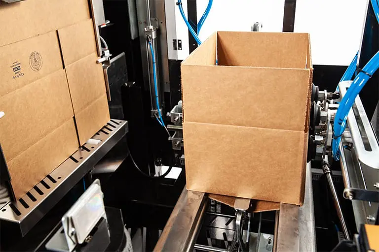 Cardboard box on automated packaging machine.