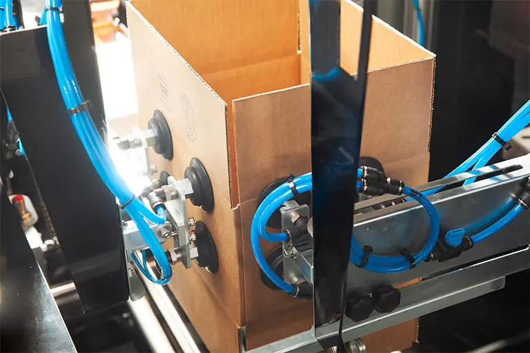 Cardboard box assembly on production line.
