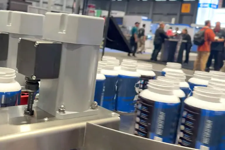 Bottles on assembly line in factory.