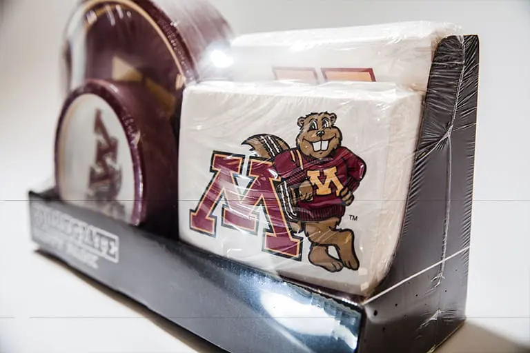 University-themed napkins and plates in packaging.