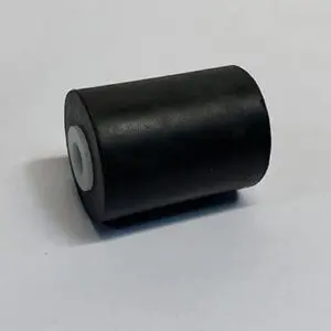 Black cylindrical object on white surface.