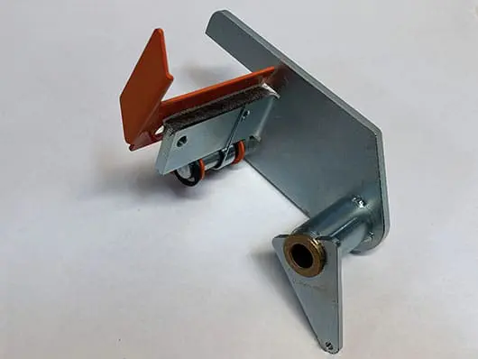 Metal bracket with orange plastic component attached.