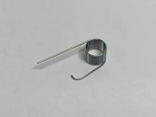 Metal coil spring on white background.