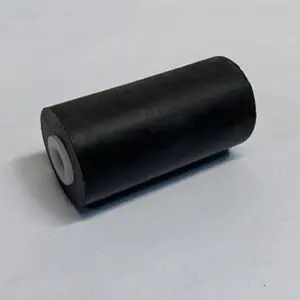 Black cylindrical roller on a gray surface.