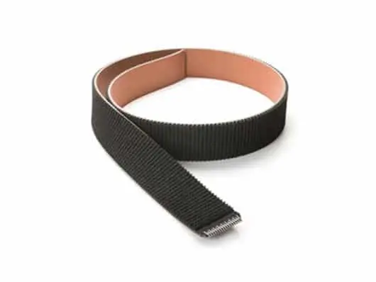 Black industrial belt coiled on surface.