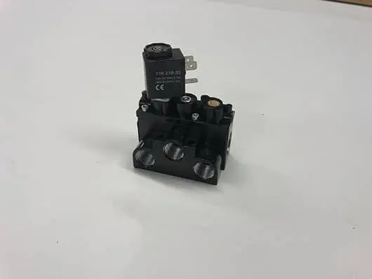 Hydraulic valve component on white background.