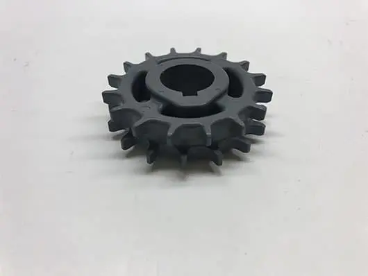 Gray plastic gear with center hole.