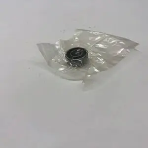 Bearing wrapped in clear plastic on table.