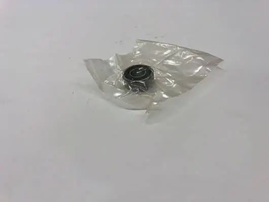 Bearing wrapped in clear plastic on table.