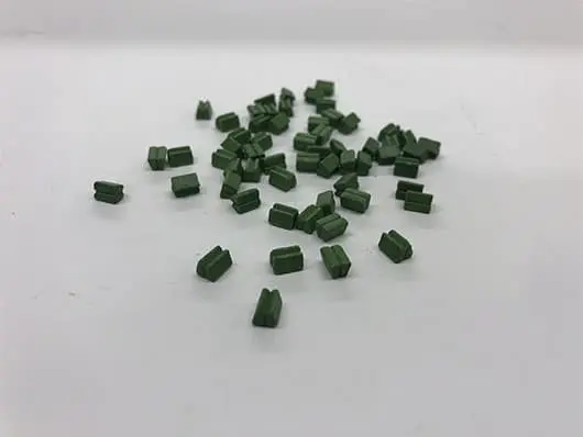 Scattered green rectangular plastic pieces.