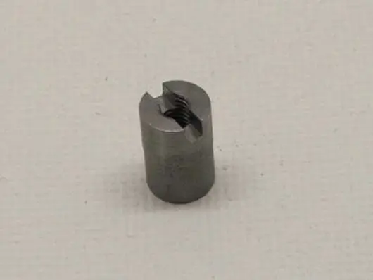 Metal cylindrical screw with internal threading.