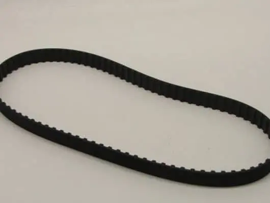 Black rubber timing belt on white background.
