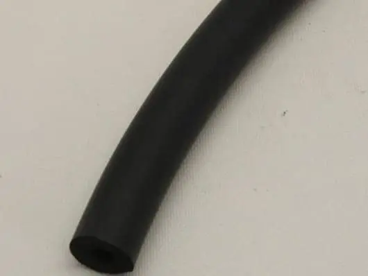 Black rubber hose on light background.