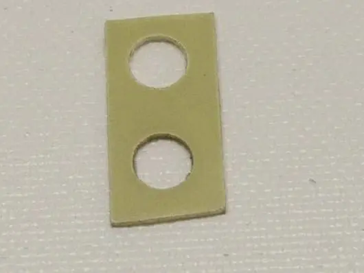 Rectangular piece with two circular holes.