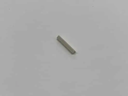 Small rectangular object on plain surface.