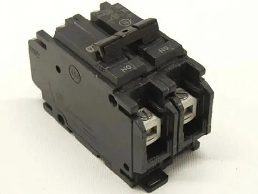 Black electrical circuit breaker on white background.
