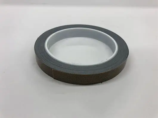 Roll of gray adhesive tape on table.