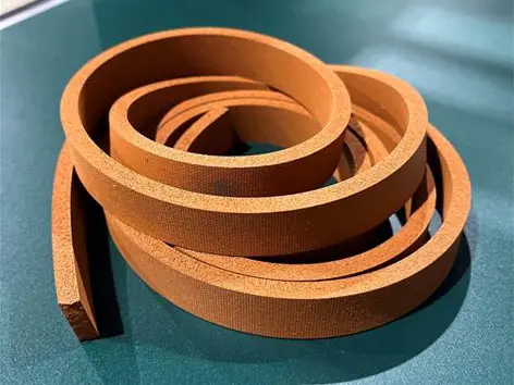 Coiled brown strip on green surface.