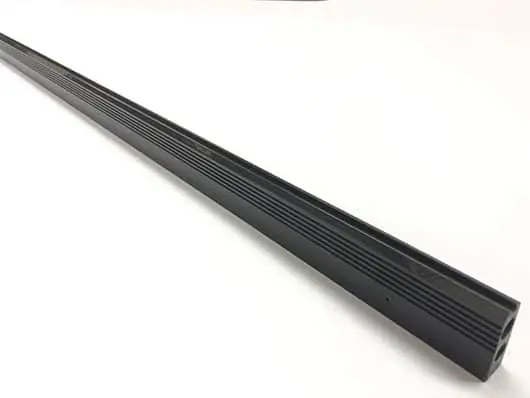 Black grooved metal rod on white background.