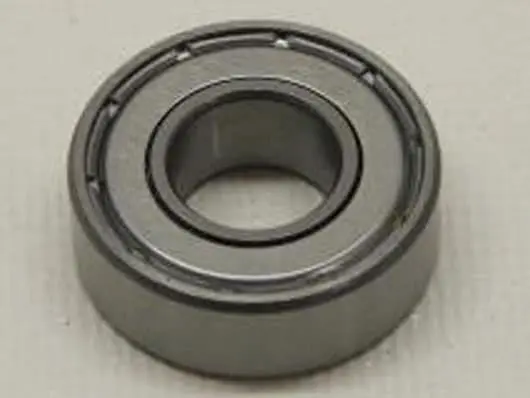 Metal ball bearing on white surface.
