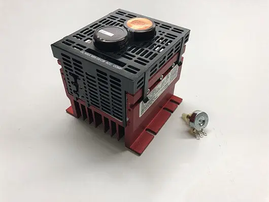 Red and black electrical device with switch.