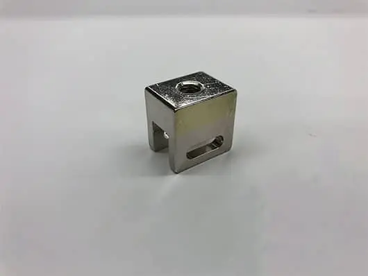 Silver metal bracket with screw hole.