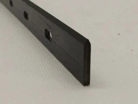 Black metal strip on white surface.
