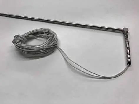 Metal probe with coiled wire on table.
