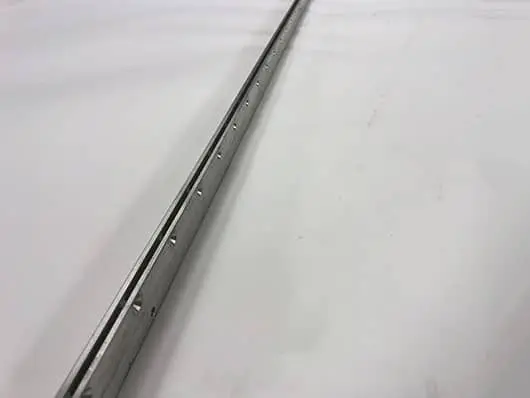 Long, silver, metal track with holes.