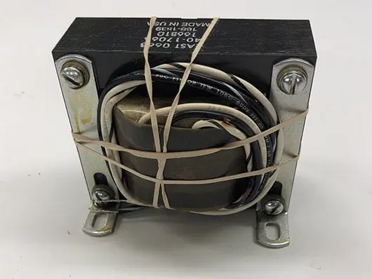 Electrical transformer with wires and rubber bands.