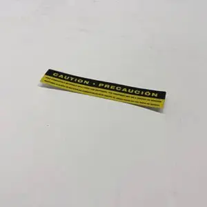 Yellow caution label on a white surface.