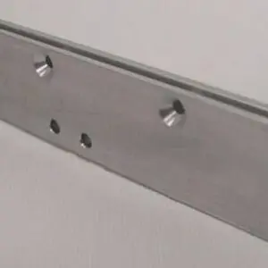 Metal bracket with multiple drilled holes.