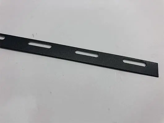 Black metal strip with elongated holes.