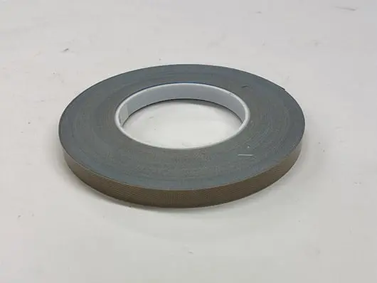 Roll of brown adhesive tape on table.