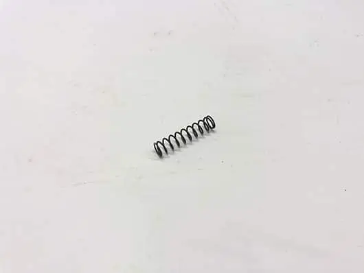 Small metal spring on white background.